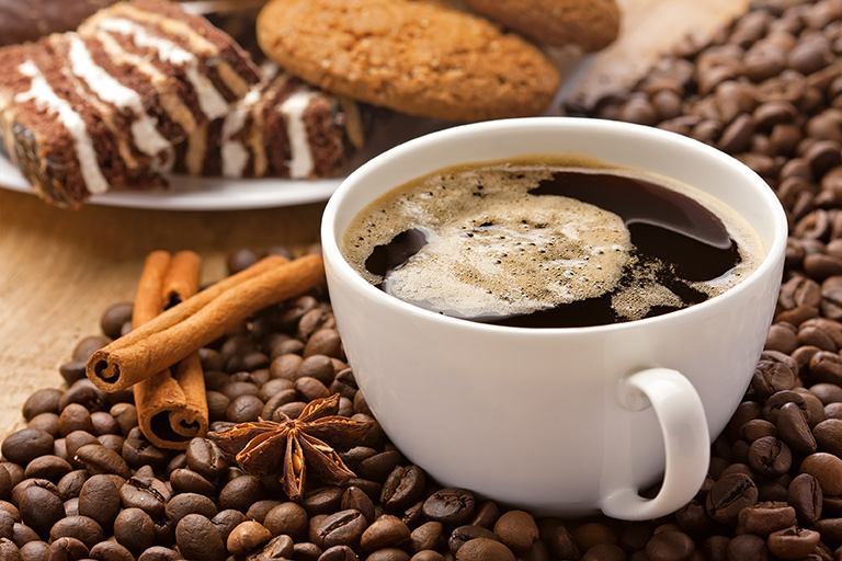 photo of coffee cup with coffee beans and spices